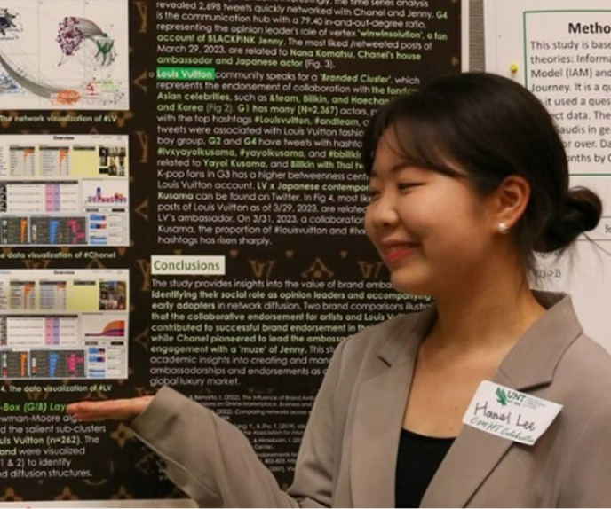 Hanel Lee posing with research